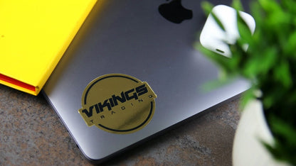Mirror gold die cut sticker applied to a laptop