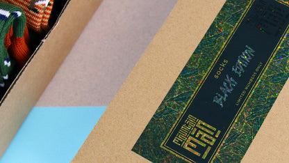 Mountain Man Socks branded glitter rectangle sticker on a box