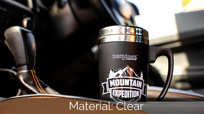 Mug sticker printed on clear vinyl with mountain expedition logo applied to a travel mug placed in a cup holder