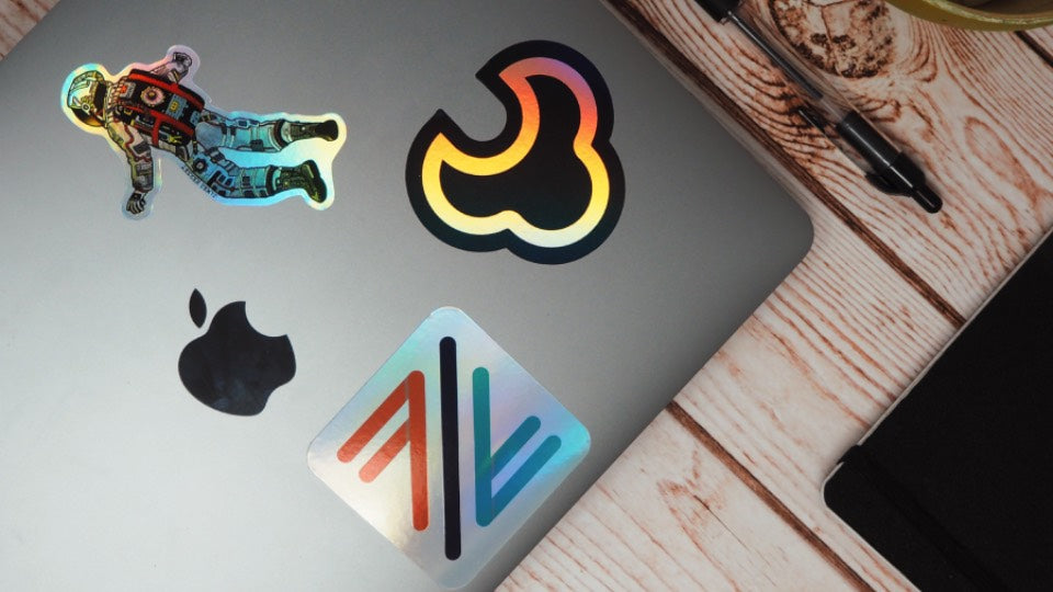 Multiple holographic stickers applied to a laptop