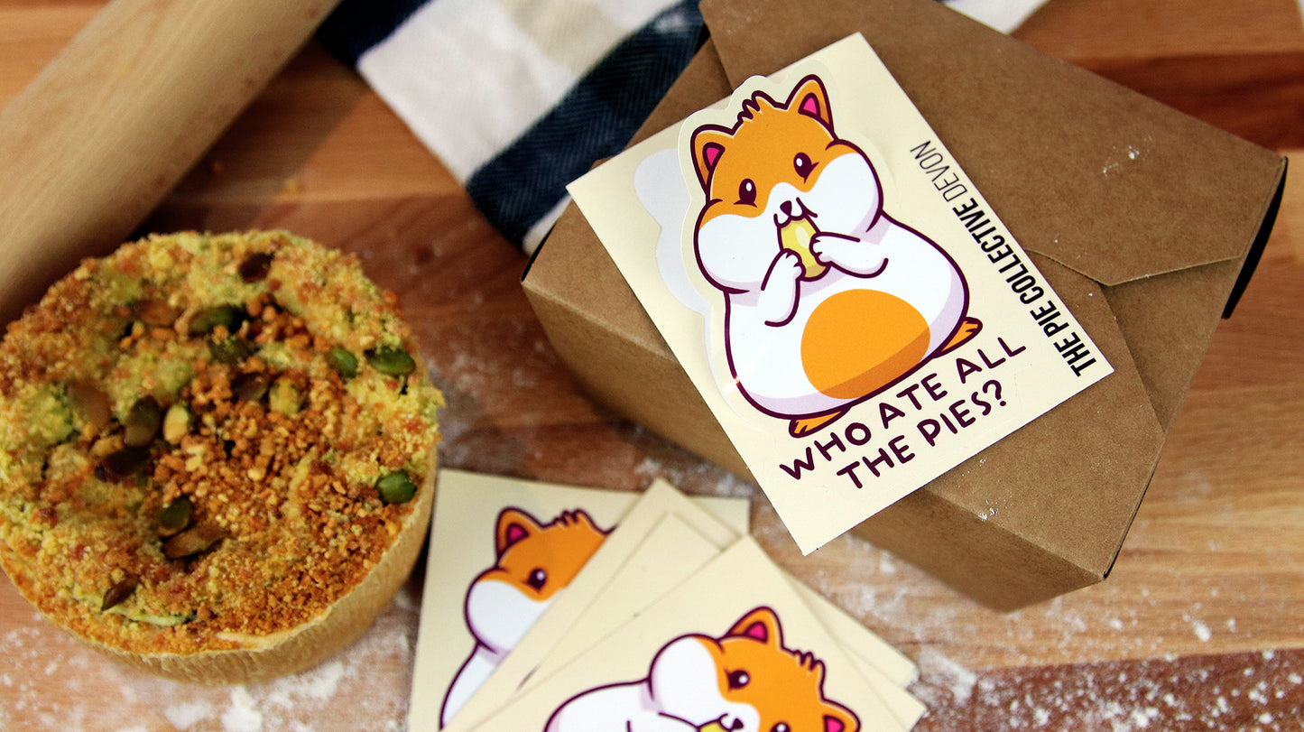 Peeled white vinyl kiss cut sticker samples with hamster design applied to a cardboard food box