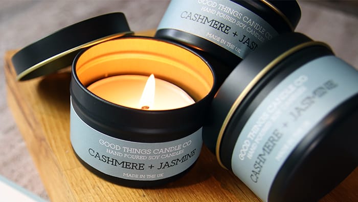 Rectangular biodegradable paper labels applied to black candle tins