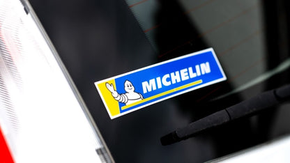 Rectangular car sticker with michelin logo applied to car window