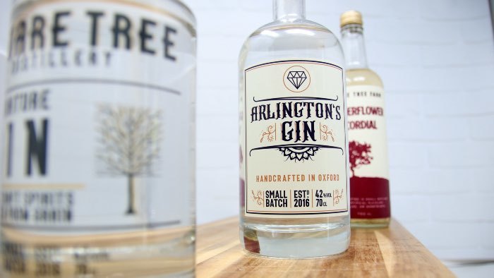 Rectangular eco-friendly clear labels applied to various clear gin bottles