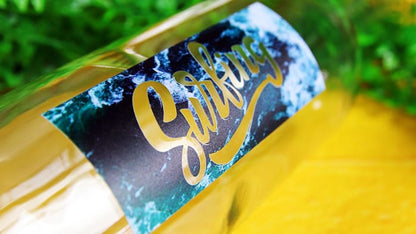 Rectangular sticker printed onto clear vinyl with surfing logo applied to a water bottle