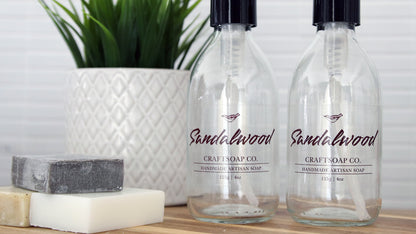 Rectangular transparent labels applied to clear soap dispensers next to bars of soap
