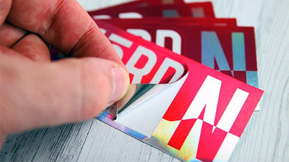 Several rectangular kiss cut sticker samples printed into holographic vinyl with Nord logo, one peeled