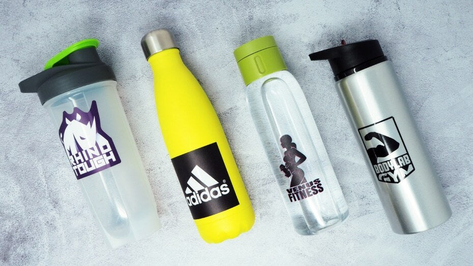 Several water bottle labels applied to four different water bottles