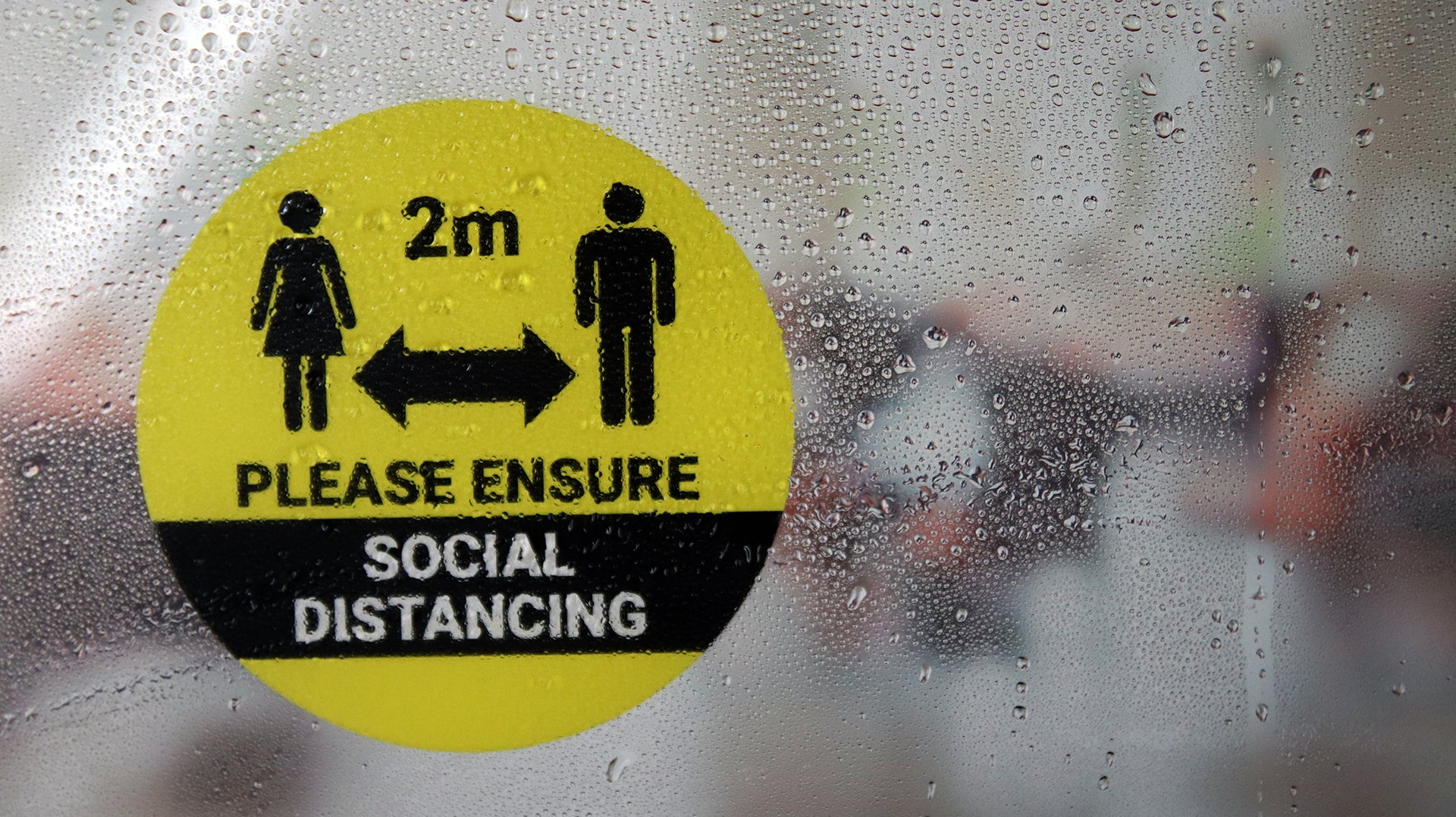 Social distancing window label front adhesive circle shape applied to a window