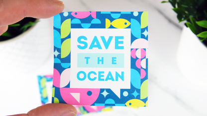Square biodegradable paper sticker with save the ocean design hand held