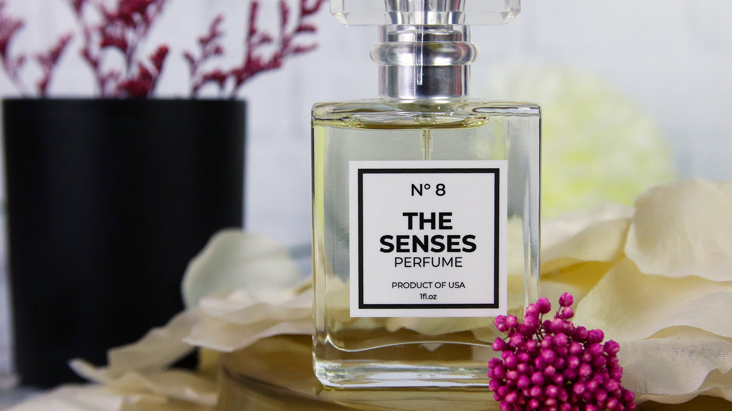 Square white vinyl sticker with the senses design applied to perfume bottle