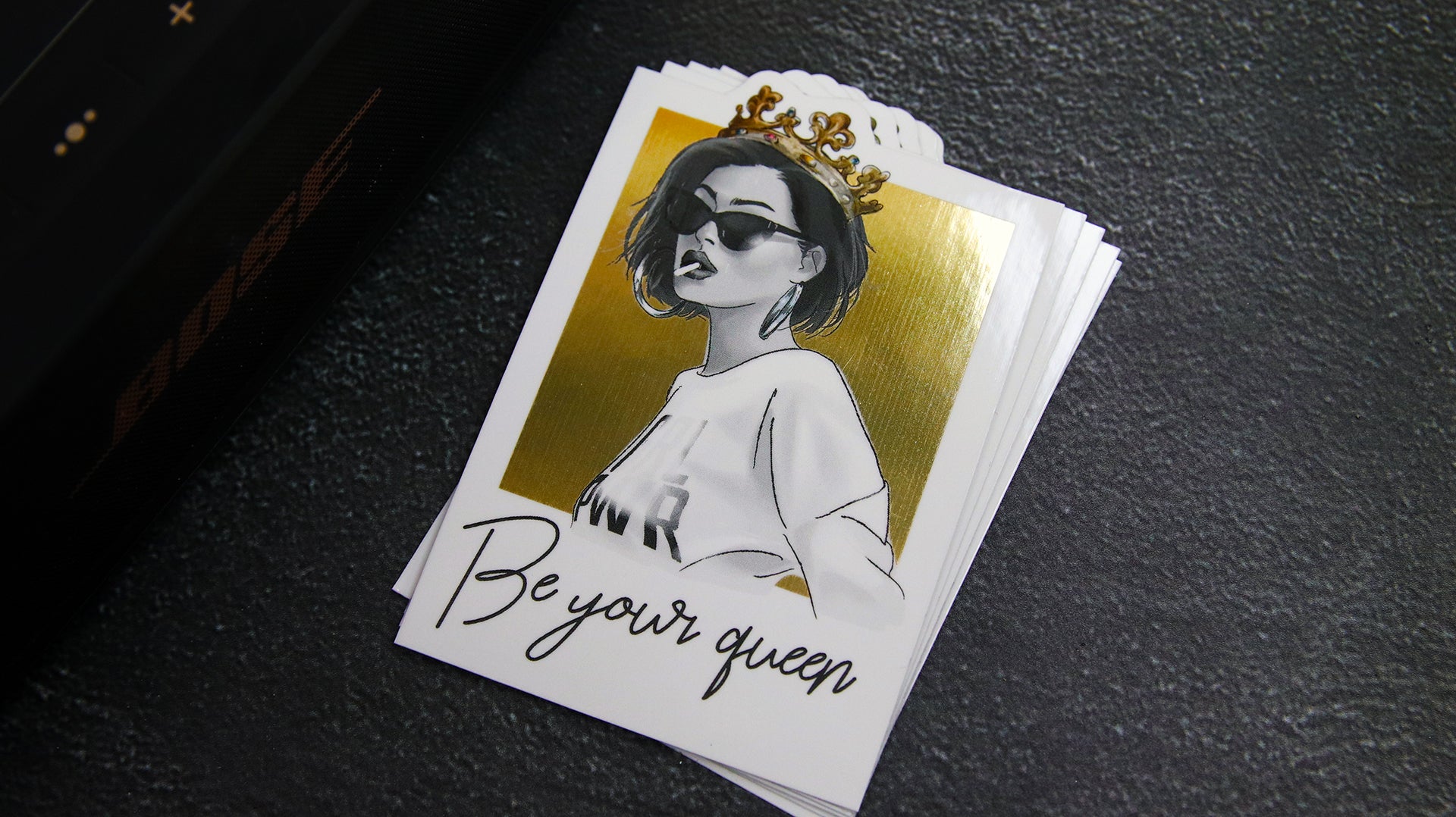 Stack of die cut eco-friendly gold samples with be your queen design