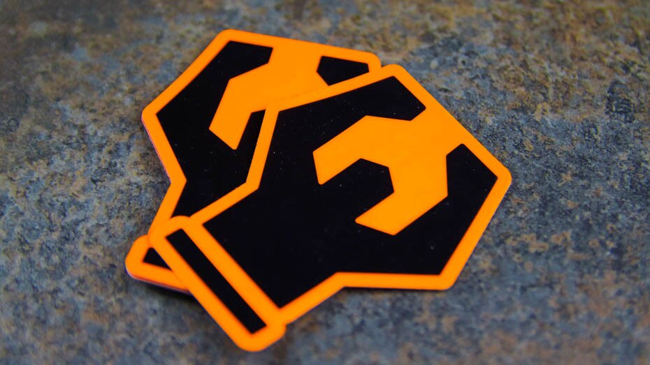 Stack of die cut fluorescent orange labels on a table
