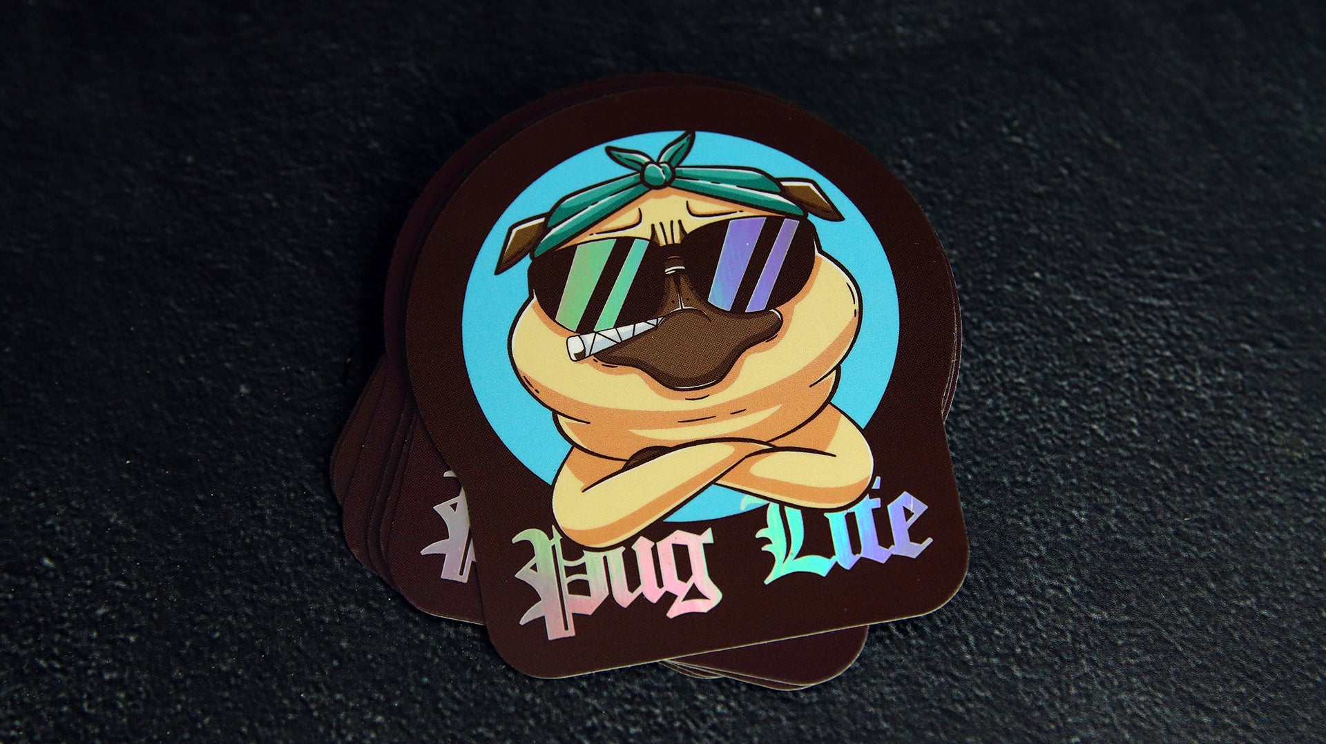 Stack of eco-friendly holographic die cut stickers with pug life design