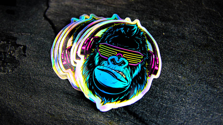 A pile of cool gorilla die cut holographic stickers on a work surface