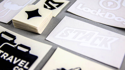 Piles of black and white transfer stickers on a light grey table
